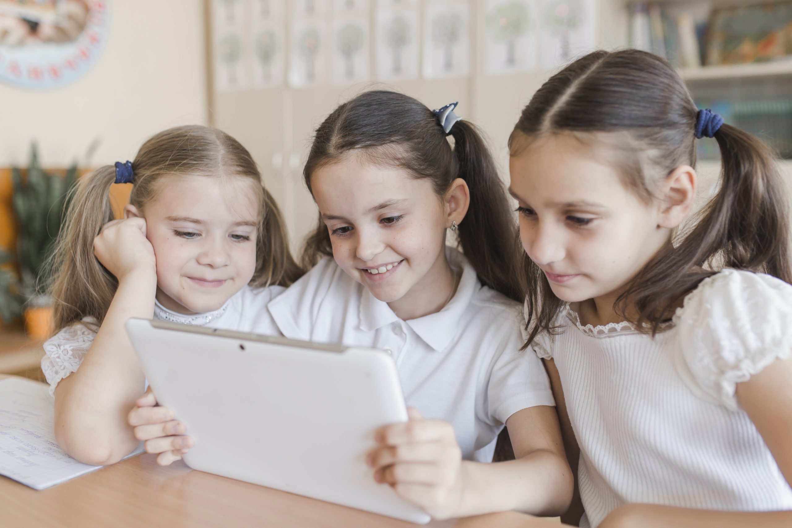 cheerful girl using tablet classroom