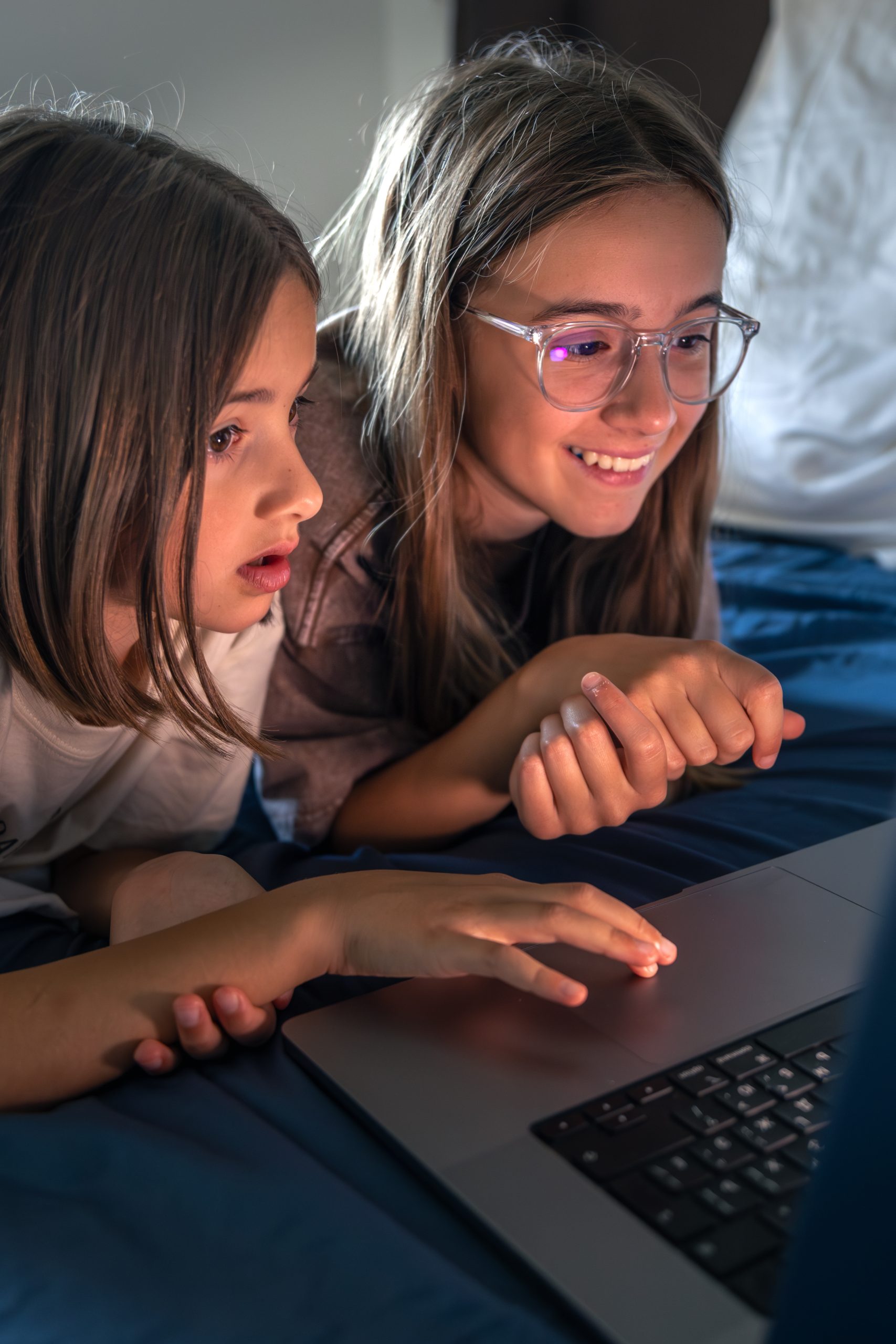 girls by laptop celebrate a find. happy girl on screen.